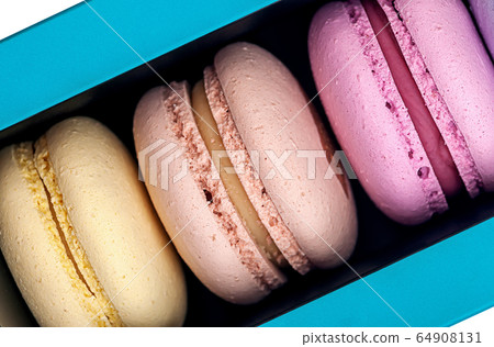 Three macaroons in box closeup 64908131
