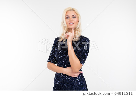 blond woman in elegant blue shiny dress makes a pensive look on a white studio background 64911511