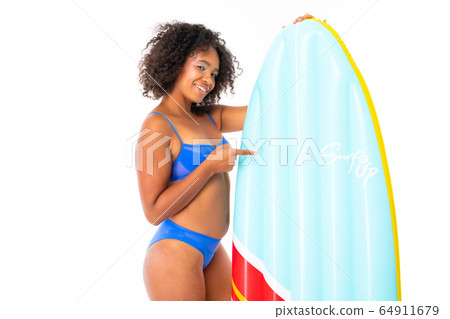 attractive african girl in a blue swimsuit holds a swimming mattress on a white background 64911679
