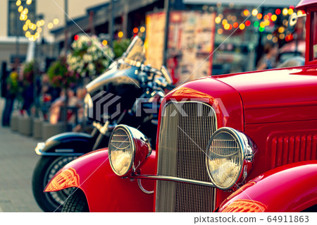 Vintage red car on the street in summer 64911863
