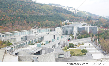View of Awaji Yumebutai building and mountain with autumn leaves 64912128
