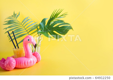 Tropical orange juice, inflatable pink flamingo. 64912250