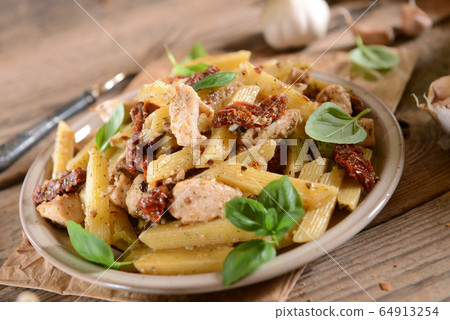 Penne pasta with chicken, dried tomatoes and Penne pasta with chicken, dried tomatoes and 64913254
