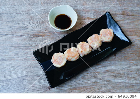steamed Chinese dumpling topping shrimp on plate dipping soy sauce steamed Chinese dumpling topping shrimp on plate dipping soy sauce 64916094