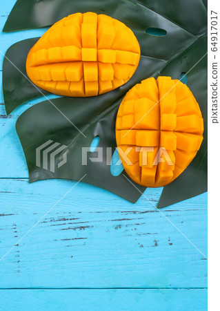 Mango cut blue background Mango cut blue background 64917017