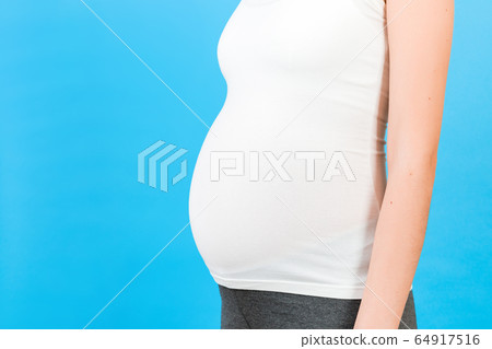 Cropped shot of pregnant abdomen in home clothing 64917516