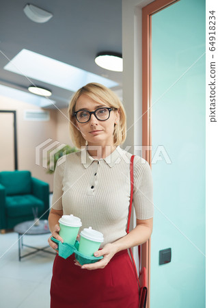 Young businesswoman with coffee Young businesswoman with coffee 64918234