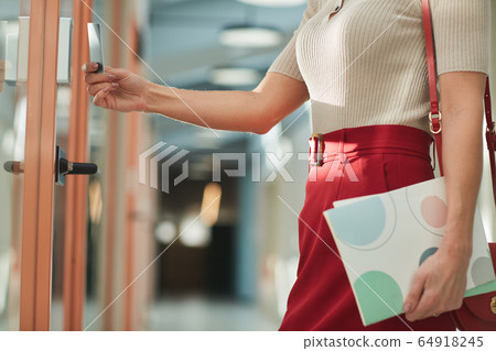 Businesswoman opening the door Businesswoman opening the door 64918245