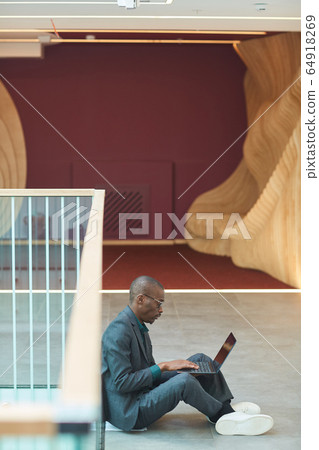 Businessman working on laptop Businessman working on laptop 64918269