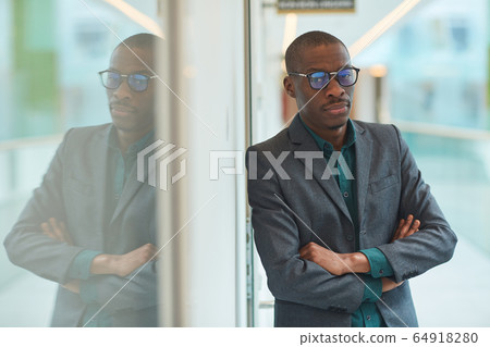 African businessman standing at office African businessman standing at office 64918280