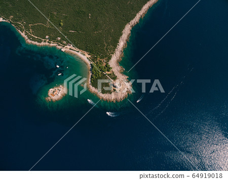 The ancient fort Arza at the entrance to the Bay of Kotor in Montenegro, in the Adriatic Sea, on the peninsula of Lustica. Fortress for military defense. Aerial photo from the drone. The ancient fort Arza at the entrance to the Bay of Kotor in Montenegro, in the Adriatic Sea, on the peninsula of Lustica. Fortress for military defense. Aerial photo from the drone. 64919018