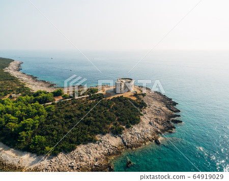 The ancient fort Arza at the entrance to the Bay of Kotor in Montenegro, in the Adriatic Sea, on the peninsula of Lustica. Fortress for military defense. Aerial photo from the drone. The ancient fort Arza at the entrance to the Bay of Kotor in Montenegro, in the Adriatic Sea, on the peninsula of Lustica. Fortress for military defense. Aerial photo from the drone. 64919029