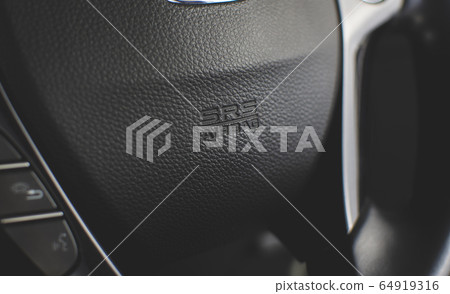SRS Airbag icon on steering wheel. 64919316