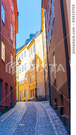 Narrow street in Stockholm. The old town (gamla stan) of the Swedish capital. Narrow street in Stockholm. The old town (gamla stan) of the Swedish capital. 64919704