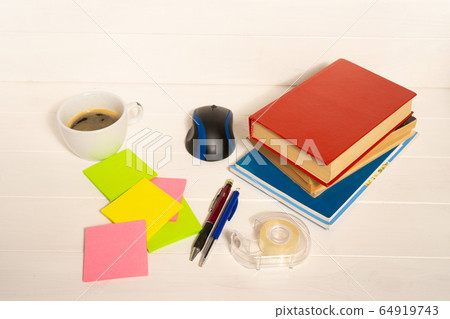 Home office concept. Work from home. Books and cafe cuo on the white wooden background. Side view. 64919743