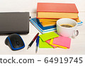 Home office concept. Work from home. Black laptop, books and cafe cuo on the white wooden background. Side view 64919745