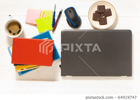 Home office concept. Work from home. Black laptop, books and cafe cuo on the white wooden background. Top view. Home office concept. Work from home. Black laptop, books and cafe cuo on the white wooden background. Top view. 64919747