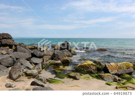 Beach and sea in bright sunlight Beach and sea in bright sunlight 64919873