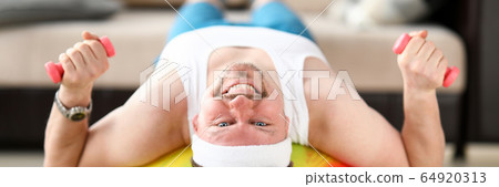 Man at home during quarantine goes in for sports Man at home during quarantine goes in for sports 64920313