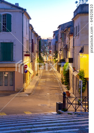 Arles. Old narrow street in the historic center of the city. Arles. Old narrow street in the historic center of the city. 64920610