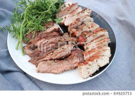 grilled pork , pork steak and beef steak 64920753