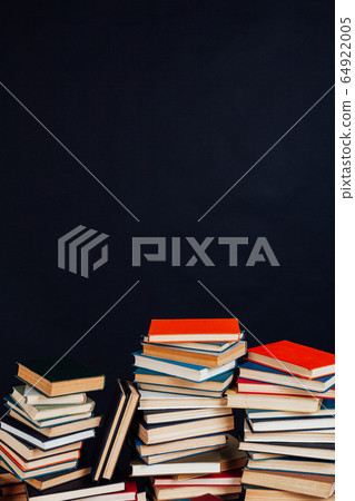 lots of stacks of educational books to teach at the college library on a black background 64922005