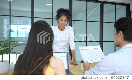 Business concept. Woman presenting a mobile Business concept. Woman presenting a mobile 64922547