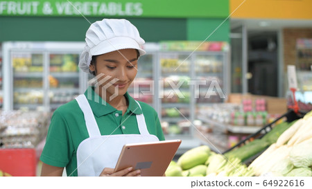 Shopping concepts. Woman using tablet to inspect Shopping concepts. Woman using tablet to inspect 64922616