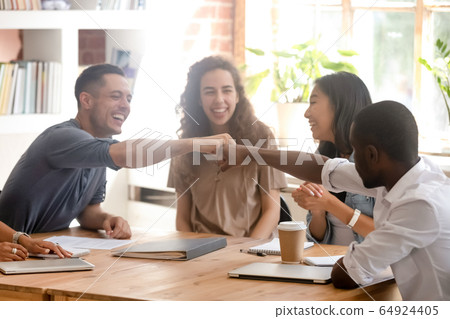 Happy diverse male colleagues students fist bumping at group meeting Happy diverse male colleagues students fist bumping at group meeting 64924405