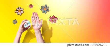 Applying sanitizer for cleaning hands with flower drawings Applying sanitizer for cleaning hands with flower drawings 64926709