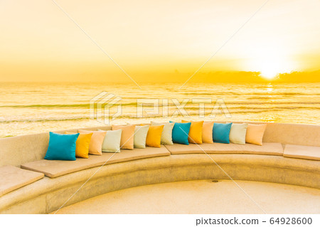 Comfortable pillow on sofa chair around outdoor patio with sea ocean beach view Comfortable pillow on sofa chair around outdoor patio with sea ocean beach view 64928600