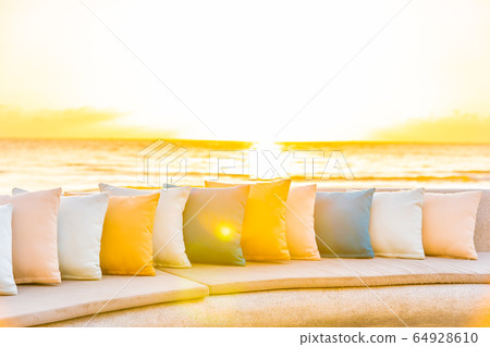 Comfortable pillow on sofa chair around outdoor patio with sea ocean beach view 64928610