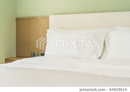 White comfortable pillow on bed decoration interior 64928614