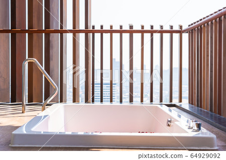 Red rose flower on water in bathtub decoration interior 64929092