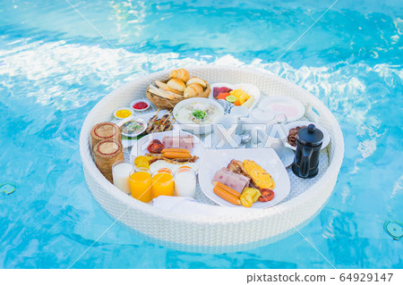 Floating breakfast set in tray with fried egg omelette sausage ham bread fruit milk juice coffee Floating breakfast set in tray with fried egg omelette sausage ham bread fruit milk juice coffee 64929147