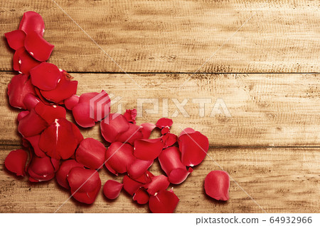 Red rose petals on wooden table Red rose petals on wooden table 64932966