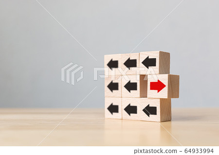 Wooden block with red arrow facing the opposite direction black arrows 64933994