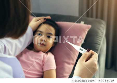 Asian female pediatrician is using a thermometer 64935946