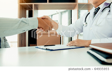 Doctor shaking hands with older patient in the Doctor shaking hands with older patient in the 64935955