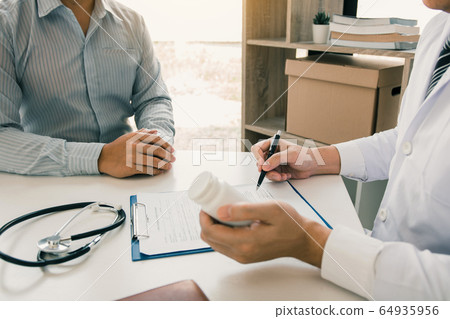 Asian male doctor hand holding pen writing patient Asian male doctor hand holding pen writing patient 64935956