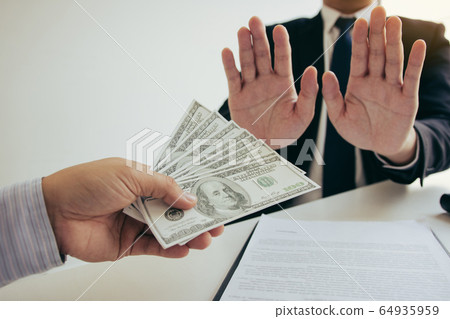 Business person refusing bribe given money by Business person refusing bribe given money by 64935959
