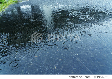 Asphalt getting wet in the rain Asphalt getting wet in the rain 64936080