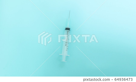 Syringe over blue background 64936473