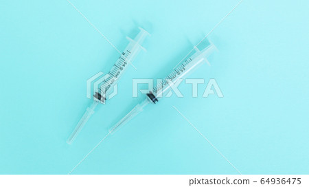 Syringe over blue background Syringe over blue background 64936475