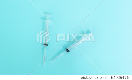 Syringe over blue background 64936476