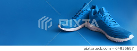 Colorful sport shoes on blue color backround Colorful sport shoes on blue color backround 64936697