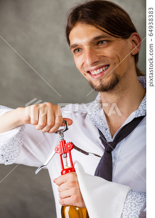 Waiter openning bottle of wine. 64938383
