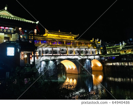 Phoenix ancient town illuminated light at night in Fenghuang city, China 64940486