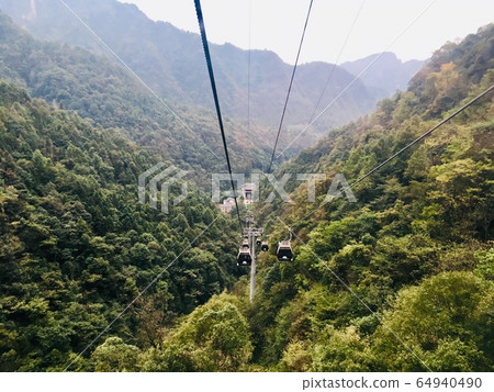 Landscape of forest mountain and cable car skyline to Tian Zhi Shan mountain at Zhangjiajie national park, China Landscape of forest mountain and cable car skyline to Tian Zhi Shan mountain at Zhangjiajie national park, China 64940490