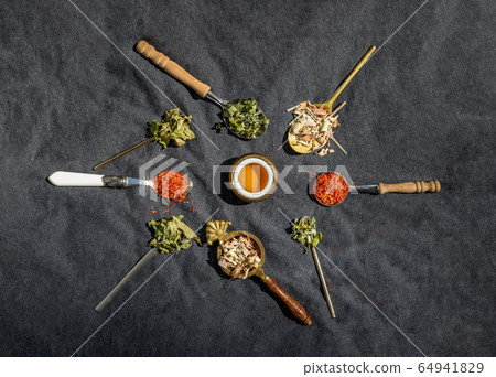 Various teas and dried herbs assortment on spoons Various teas and dried herbs assortment on spoons 64941829